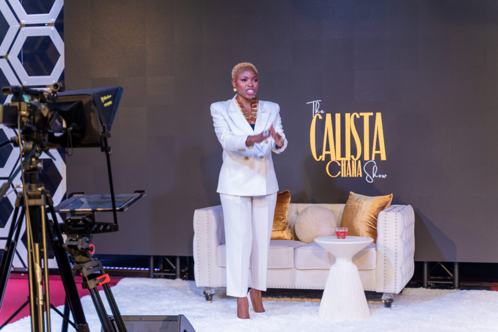 black-American-putting-on-a-white-female-suit-and-standing-on-a-video-stage-infront-of-camera