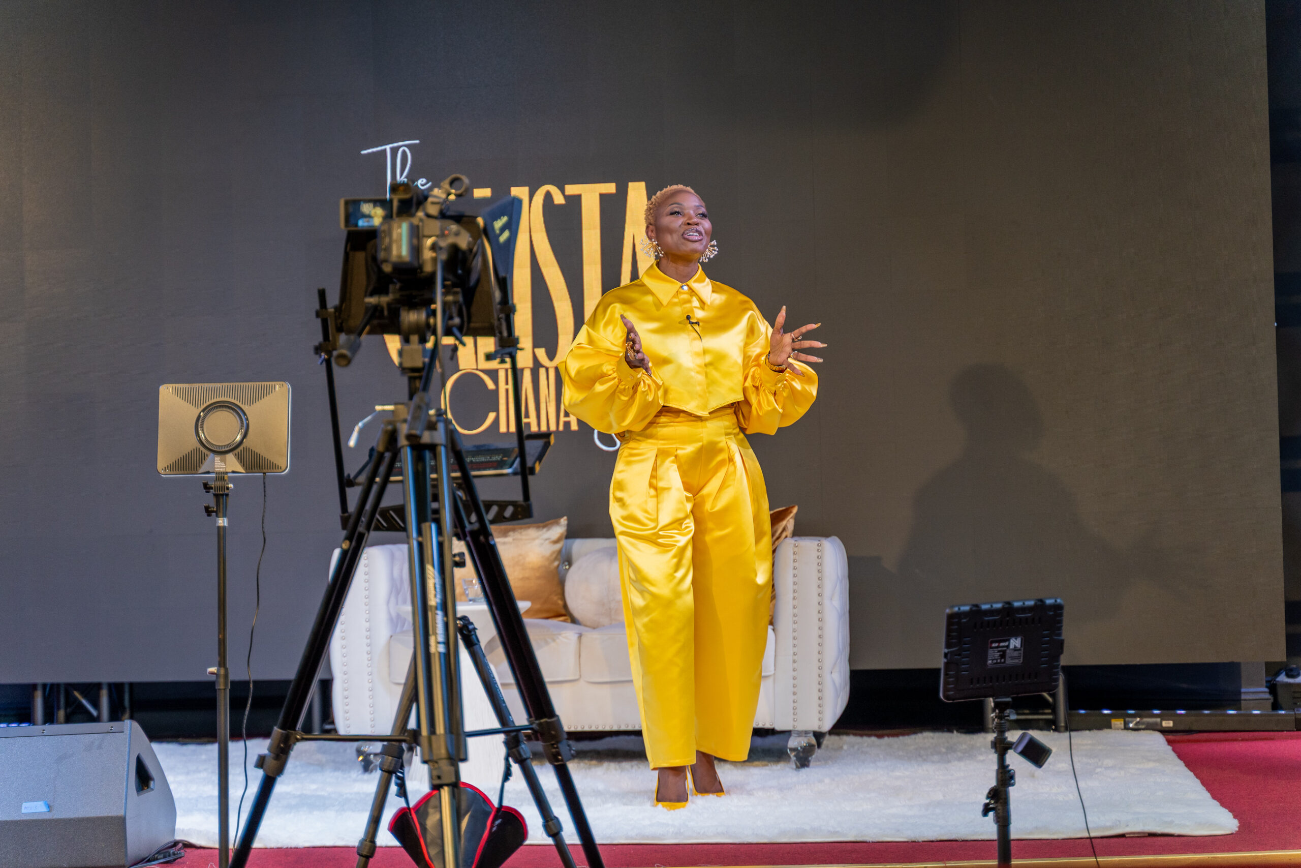 black-American-putting-on-a-yellow-dress-and-standing-on-a-video-stage-infront-of-camera