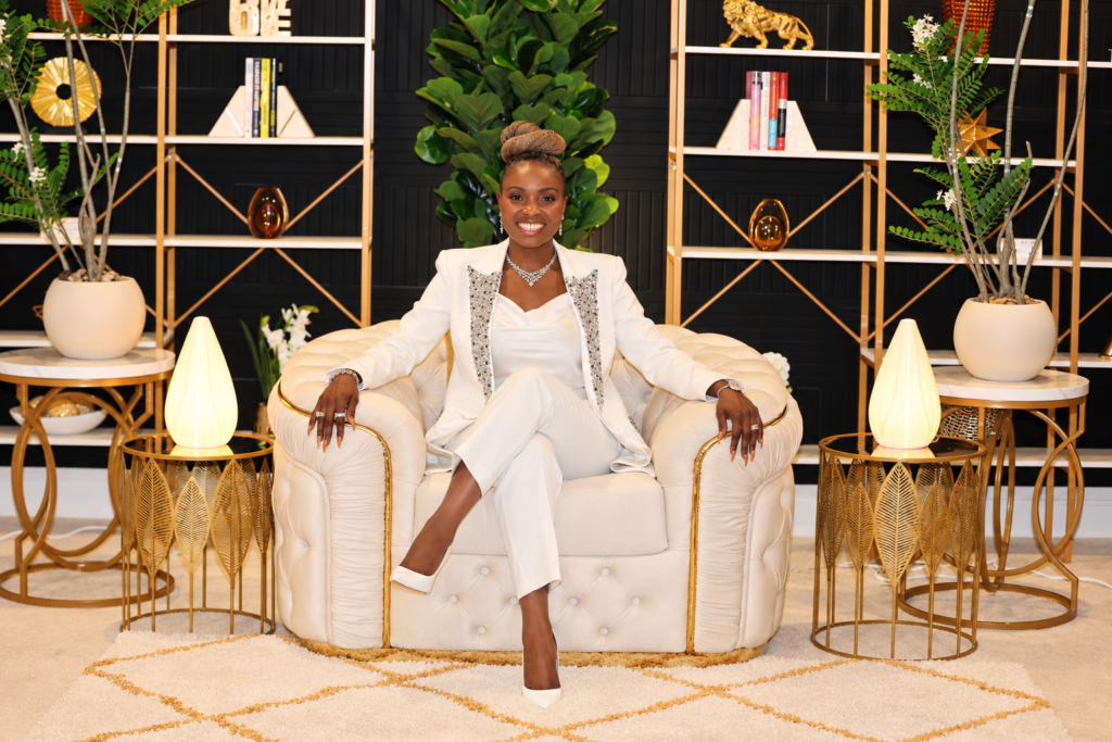 black american female sitting on a white couch