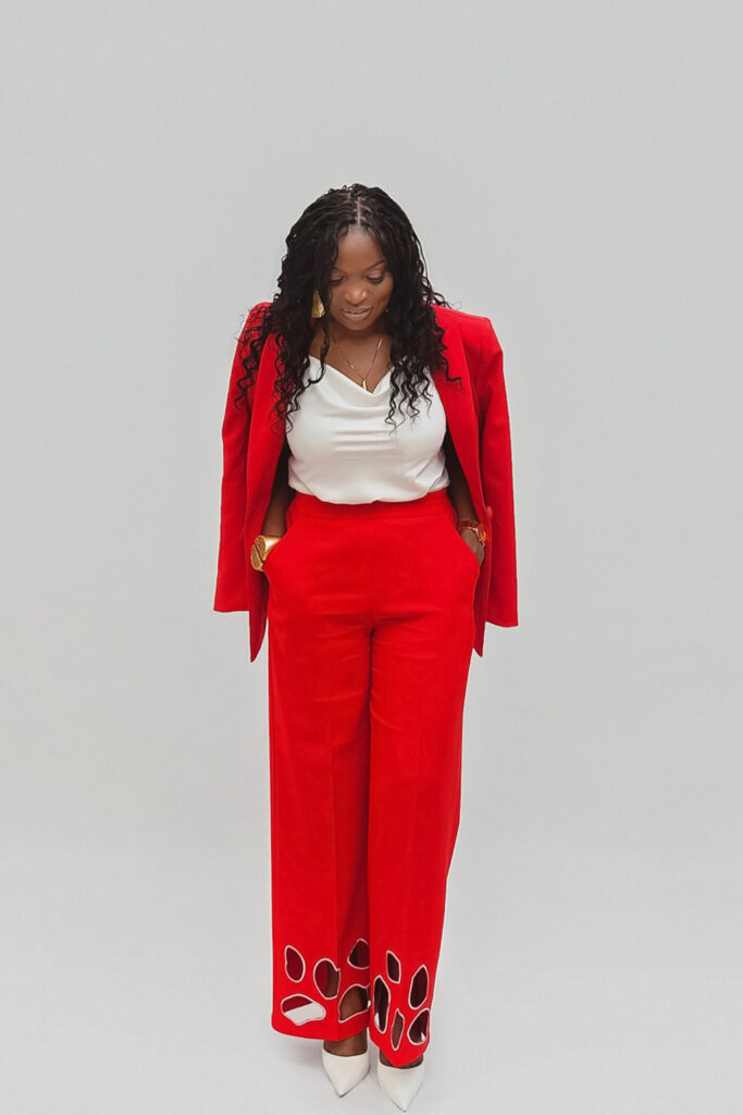 pastor calista on a white studio background with a red suit